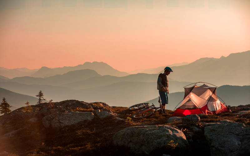 A person on a cliff learning about healthy coping skills for long-term recovery.