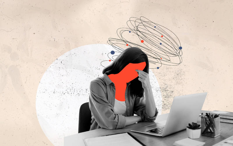 A cartoon image of a woman experiencing emotional exhaustion at her office desk.