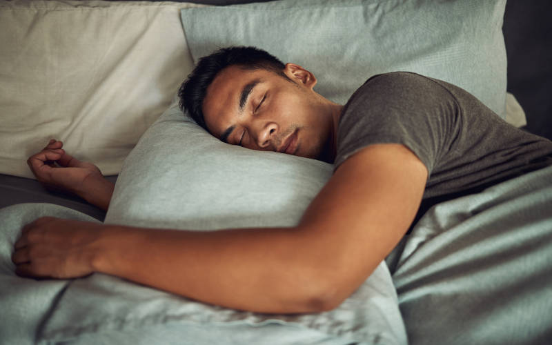 A young man sleeping, an important part of the recovery process for mental health challenges and addiction.