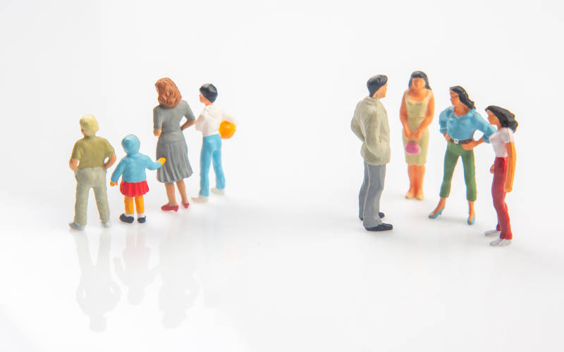 A picture of toy human figures representing two different family dynamics.