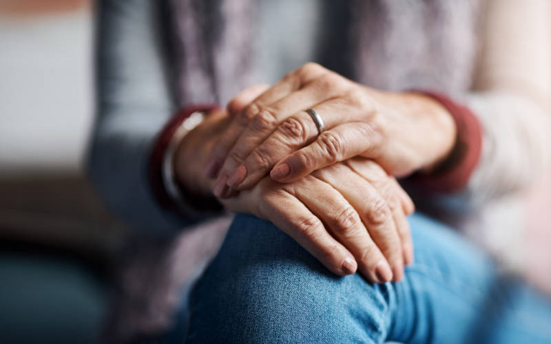 A picture of the hands of an older woman who has unresolved trauma.