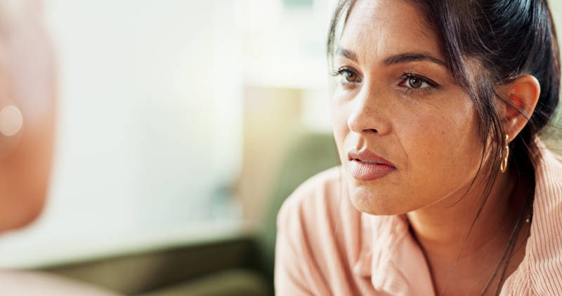 A woman in therapy learning about PTSD vs. complex PTSD.